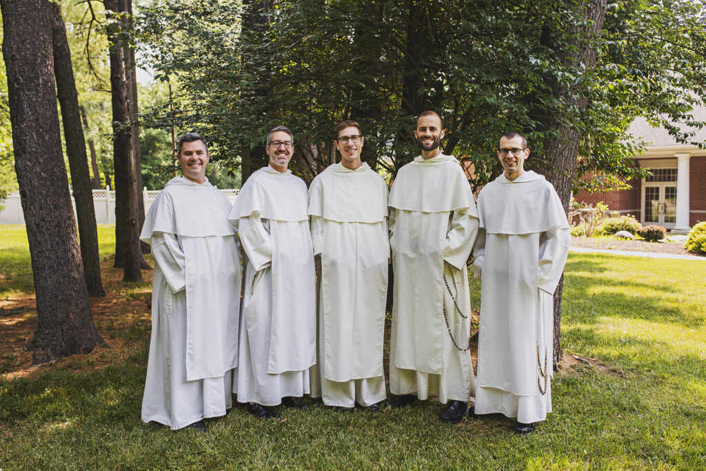 Picture of the 5 friars of Godsplaining standing outside